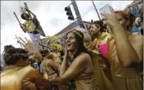  ?? GERALD HERBERT, AP FILE PHOTO ?? Revelers congregate at the start of the Society of Saint Anne Mardi Gras parade in New Orleans. The city celebrates its tricentenn­ial in 2018.