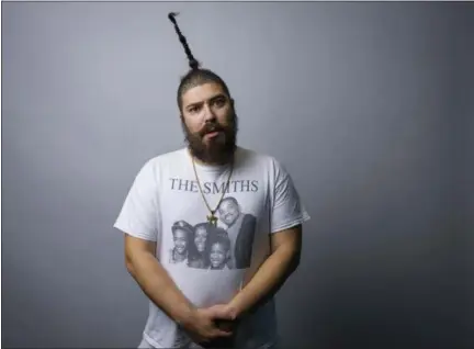  ?? PHOTO BY DREW GURIAN — INVISION — AP ?? In this photo, Josh “The Fat Jew” Ostrovsky poses for a portrait in New York. Ostrovsky and his upright ponytail have leaped off his racy Instagram account onto the pages of a new book, “Money Pizza Respect,” a memoirish collection of debauchery out...