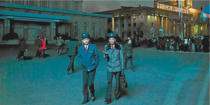  ??  ?? North Korean students walk past the central station in Pyongyang last month.