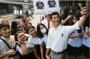  ??  ?? Good shot: Thanathorn taking selfies with students during his election campaign rally at Siam University in Bangkok. — AP