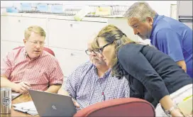  ?? BOB ANDRES PHOTOS / BANDRES@AJC.COM ?? In the new city of South Fulton, Tim Inglis (from left), Brian Epstein, Michelle Macauley and Ringo McCollum prepare for the first day of building inspection­s to start today.