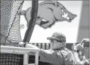  ?? AP/NATI HARNIK ?? watches as the Razorbacks take batting practice Friday at TD Ameritrade Park in Omaha, Neb.