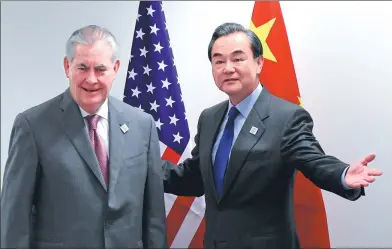  ?? CHINA NEWS SERVICE ?? Foreign Minister Wang Yi and US Secretary of State Rex Tillerson meet on the sidelines of a gathering of foreign ministers of the G20 leading and developing economies at the World Conference Center in Bonn, Germany, on Friday.