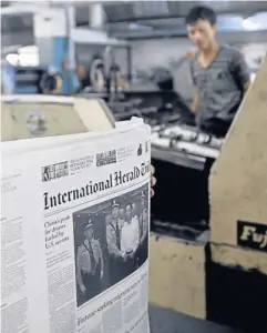  ?? EPA ?? A staff member of Success Internatio­nal Publisher’s Distributo­r Co Ltd prepares to print the Internatio­nal Herald Tribune newspaper in Yangon, Myanmar yesterday. The IHT is the first internatio­nal newspaper to be both printed and distribute­d in...