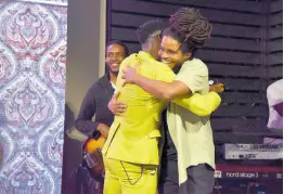  ?? ?? Ras-I embraces Romain Virgo (left) on stage.