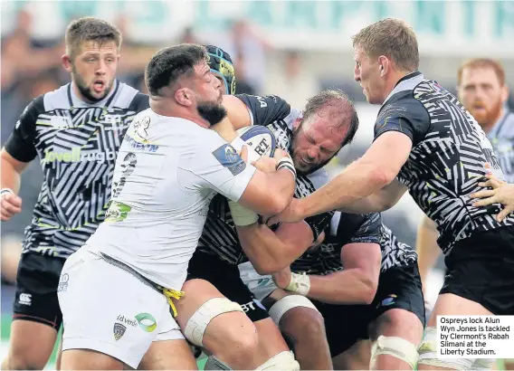  ??  ?? Ospreys lock Alun Wyn Jones is tackled by Clermont’s Rabah Slimani at the Liberty Stadium.