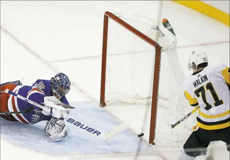  ?? Julie Jacobson/Associated Press ?? Evgeni Malkin’s shot into an open net in overtime saved the Penguins Tuesday night in New York.