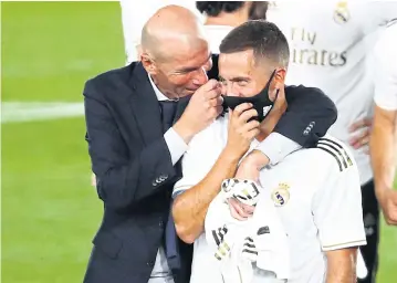  ?? REUTERS ?? Real Madrid coach Zinedine Zidane hugs Eden Hazard as they celebrate winning the La Liga title last month.