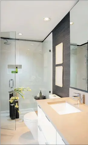  ??  ?? The bathroom has a shower bench, niche and rain shower bar with thermostat­ic controls.