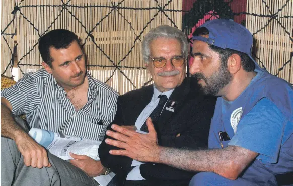  ?? AFP ?? Above, Sheikh Mohammed bin Rashid with Egyptian film star Omar Sharif, centre, and Bashar Al Assad in Palmyra, Syria, in 1999; Saddam Hussein at the headquarte­rs of the Republican Guards in Baghdad in 2003. He was captured by US forces in December the same year