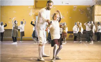  ?? CFI Releasing ?? Estonian fencing legend Endel Nelis (Mart Avandi) gives a few pointers to one of his students, Marta (Liisa Koppel), in “The Fencer,” set in a small town in postwar Estonia.