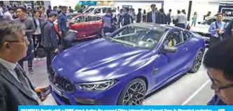  ?? —AFP ?? SHANGHAI: People visit a BMW stand during the second China Internatio­nal Import Expo in Shanghai yesterday.
