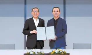  ?? Courtesy of KB Financial Group ?? KB Financial Group Chairman Yoon Jong-kyoo, left, poses with LG Corp. Vice Chairman Kwon Young-soo after signing an agreement to boost cooperatio­n in digital technology at the LG Science Park in Seoul, Monday.