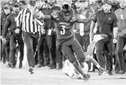  ?? MARK HUMPHREY/AP ?? Louisville QB Micale Cunningham tries to stay inbounds during the Cardinals’ bowl win over Mississipp­i State on Monday.