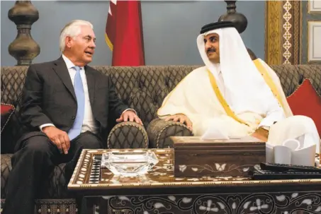  ?? AFP / Getty Images ?? Secretary of State Rex Tillerson brokered a deal with Qatar’s Emir Sheikh Tamim bin Hamad al Thani in the capital Doha.