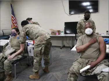  ?? ROGELIO V. SOLIS — ASSOCIATED PRESS FILE ?? In a Dec. 23, 2020, photo, members of the Mississipp­i Air and Army National Guard Guard receive the first dose of the Moderna COVID-19 vaccine in Flowood, Miss.