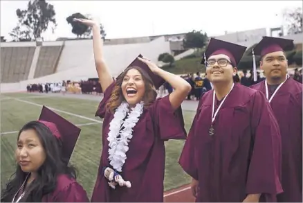  ?? Photograph­s by Harrison Hill Los Angeles Times ?? VANESSA DELIRA, a student at Owensmouth High School, waves to her family during the graduation ceremony in the football stadium at East Los Angeles College. Alternativ­e schools serve students who need to recover credits or learn on f lexible schedules.