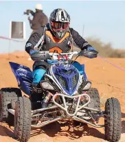  ?? ?? TEARING UP TERRAIN: Quad biking through tough desert sands