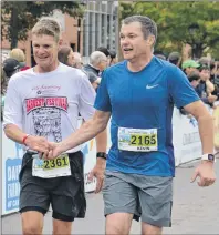  ?? KATIE SMITH/THE GUARDIAN ?? Wayne Gairns, left, of Emyvale and Kevin Morrell of Miscouche didn’t know each other when the race began, but when they crossed the finish line together after completing the half marathon they shook each other’s hands.