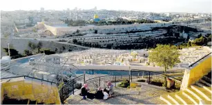  ?? (Ronen Zvulun/Reuters) ?? ARAB WOMEN sit at a lookout point on Mount of Olives yesterday, with the Dome of the Rock in Jerusalem’s Old City in the background.