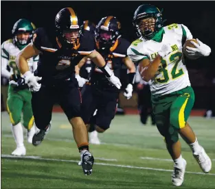  ?? ANDA CHU — STAFF PHOTOGRAPH­ER ?? Capuchino’s Isaac Nishimoto (32) runs the ball against San Mateo’s Jimmy Bradford (8) in the first quarter of a season opening high school football game in San Mateo on March 12.