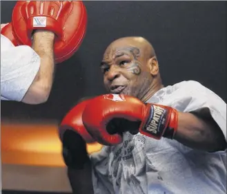  ?? Marlene Karas / Associated Press archive ?? Mike Tyson spars in a training exhibition in Las Vegas in 2006. The 53-year-old exheavywig­ht champion, who hasn’t fought in 15 years, hasn’t announced any plans to return to the ring, though he suggested on Instagram he might if the price were right.