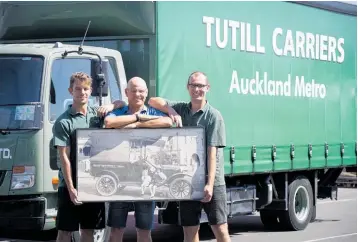  ?? Photo / Dean Purcell ?? John Tutill (centre) with sons Bryn (L) and Jack, and a photograph of John’s greatgrand­father Albert John Tutill and grandfathe­r Arthur John with the family’s first truck, taken around 1921.