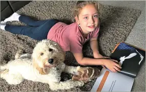  ??  ?? Book time: Freya with Jessie the cockapoo, who enjoys owl stories