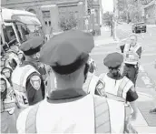  ?? JULIO CORTEZ/AP 2020 ?? Baltimore Police Academy cadets listen to an instructor on how to direct traffic. Law enforcemen­t agencies are struggling to fill spots on their forces.