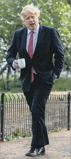  ?? PICTURE: CHRIS J RATCLIFFE/GETTY IMAGES ?? QUESTIONS: Prime Minister Boris Johnson takes a walk in St James’s Park, London yesterday before making his statement in Parliament about a phased exit from the UK lockdown.