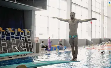  ?? Thibault Camus/Associated Press ?? Ukrainian diver Stanislav Oliferchyk prepares during a practice session in Kyiv, Ukraine. The path to the 2024 Paris Olympics for Ukrainian athletes is clouded by war, anger and pain. Russian bombardmen­ts have wrecked training venues. Air raids disrupt training sessions. Athletes have lost family members and friends. Or they worry that they will.