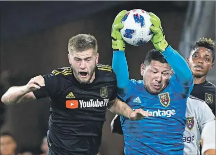  ?? Photograph­s by Wally Skalij Los Angeles Times ?? REAL SALT LAKE goalie Nick Rimando makes the save in the first half as LAFC’s Walker Zimmerman tries to put in a header.