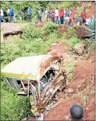  ?? Picture: AFP ?? TRAGIC REMAINS: Passersby stare at the wreckage of a bus in which dozens of small children died