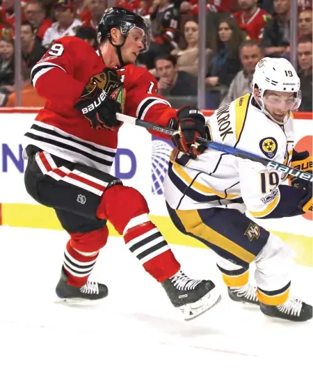  ??  ?? Blackhawks captain Jonathan Toews and the Predators’ Calle Jarnkrok battle for the puck during Game 1. | GETTY IMAGES