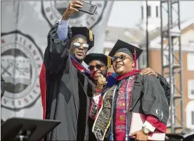  ??  ?? Former Tallahasse­e Mayor and candidate for Florida governor Andrew Gillum (left) takes a selfie with a graduate at Clark Atlanta’s commenceme­nt ceremony.