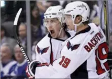  ?? FRANK GUNN — THE CANADIAN PRESS VIA AP ?? Washington’s T.J. Oshie (77) celebrates his goal with teammate Nicklas Backstrom during the third period in Toronto on Wednesday.