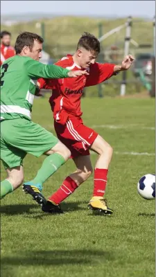  ??  ?? MCR v Strand: Gary McCartney tries to dispossess Cian Conway.