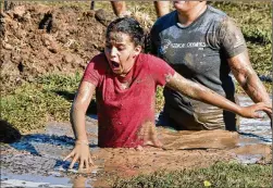  ??  ?? Leiana Williams braves the Ice Pit during the Muddy Miler event. Saturday’s 2½-hour outdoor adventure featured a series of obstacle competitio­ns that the city promised “would offer more fun than your average run event.”