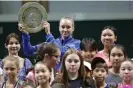  ?? Photograph: Pavel Mikheyev/Reuters ?? Elena Rybakina with the Wimbledon trophy and local children in Nur-Sultan.