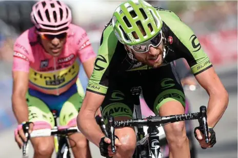  ?? DANIEL DAL ZENNARO/THE ASSOCIATED PRESS ?? Ryder Hesjedal of Canada, right, crosses the finish line at the end of the 18th stage of this year’s Giro d’Italia, where he placed fifth.
