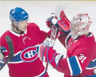  ?? GRAHAM HUGHES/THE CANADIAN PRESS ?? Montreal Canadiens goaltender Carey Price celebrates with teammate Jacob De La Rose after the Habs defeated the Buffalo Sabres 3-0 on Saturday at the Bell Centre.