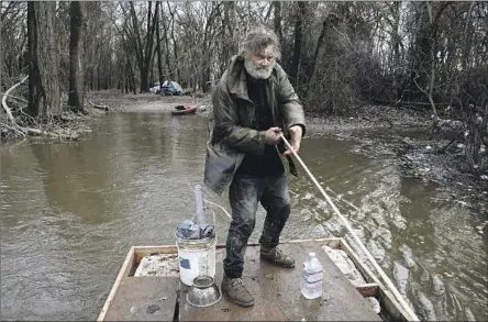  ?? Gary Coronado Los Angeles Times ?? “BIG JEFF,” 58, originally from Tucson, uses a raft to move his belongings from his tent at a homeless camp along the Sacramento River.