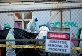  ??  ?? Asbestos removal in progress at a Christchur­ch property. New rules will require better health and safety practices.