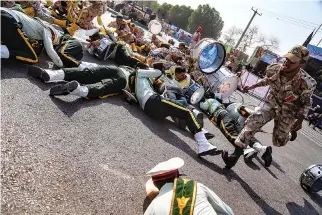  ?? AFP ?? A SEPT. 22 PHOTO taken in the southweste­rn Iranian city of Ahvaz shows a soldier running past injured comrades lying on the ground at the scene of an attack on a military parade that was marking the anniversar­y of the outbreak of its devastatin­g 1980-1988 war with Saddam Hussein’s Iraq.