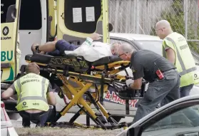  ?? AP ?? TERROR ATTACK. Ambulance staff take a man from outside a mosque in central Christchur­ch, New Zealand, Friday, March 15, 2019. /