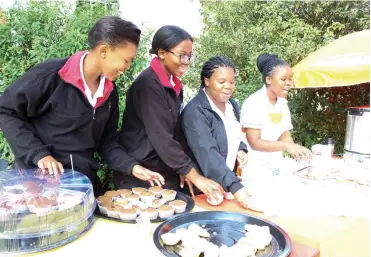  ?? Photo: Sue Maclennan ?? Kingswood College pupils Tina Modasa, Lavela Booi, Lubby Zote and Sali Bokani serve tea and delicious eats at the Brookshaw fete recently.