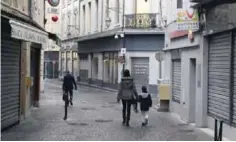  ??  ?? MONTELIMAR: People walk past closed stored during a “Lifeless town operation” (“Operation ville morte”) as storekeepe­rs protest against the depopulati­on of the city center and the constructi­on of a shopping mall in the outskirt of the town yesterday in...