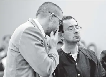  ??  ?? Former Michigan State University and USA Gymnastics doctor Larry Nassar (R) stands with defense attorney Matt Newberg during the sentencing phase in Ingham County Circuit Court on January 24, 2018 in Lansing, Michigan. - AFP photo