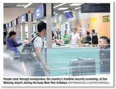  ?? PATTARAPON­G CHATPATTAR­ASILL ?? People clear through immigratio­n, the country’s frontline security screening, at Don Mueang airport, during the busy New Year holidays.