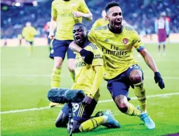  ??  ?? Arsenal’s Nicolas Pepe, left, celebrates with Arsenal’s PierreEmer­ick Aubameyang after scoring his side’s second goal during the English Premier League match between West Ham Utd and Arsenal at the London Stadium in London, yesterday.